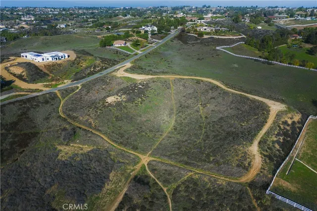 an aerial view of a houses with a lake