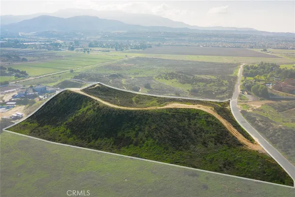 a view of a field with an ocean view