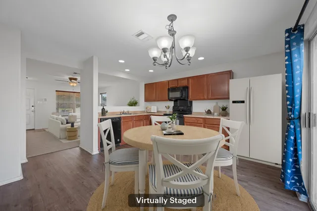 a view of a dining room with furniture and wooden floor