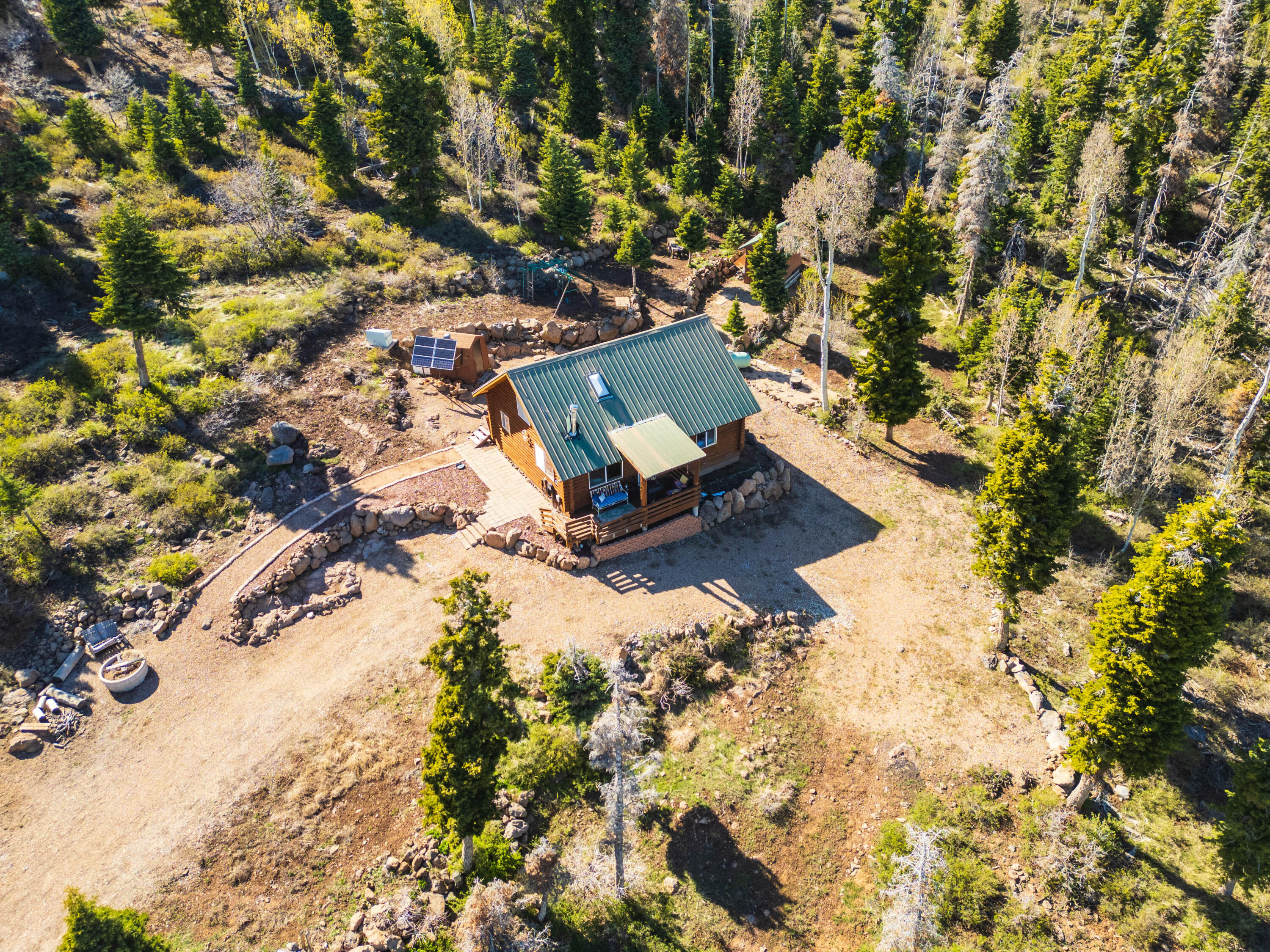 706 West Tranquility Drive Springdale, UT 84767 - Photo 39 of 58 Secluded Mountain Living: Wide aerial shot showing the cleared site within the forest.
