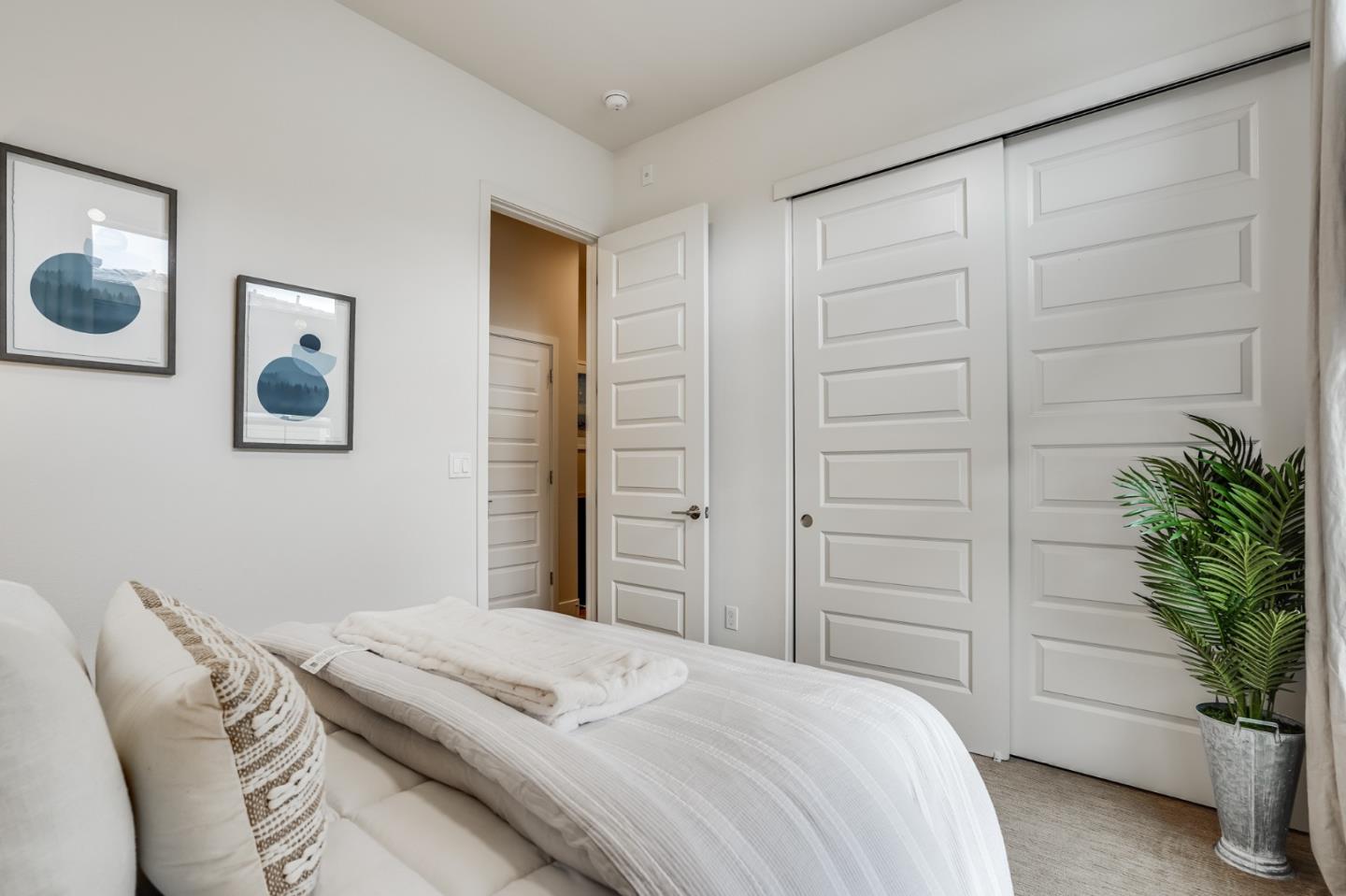 465 Landeros Drive San Mateo, CA 94403 - Photo 15 of 36 a bedroom with a bed and a potted plant