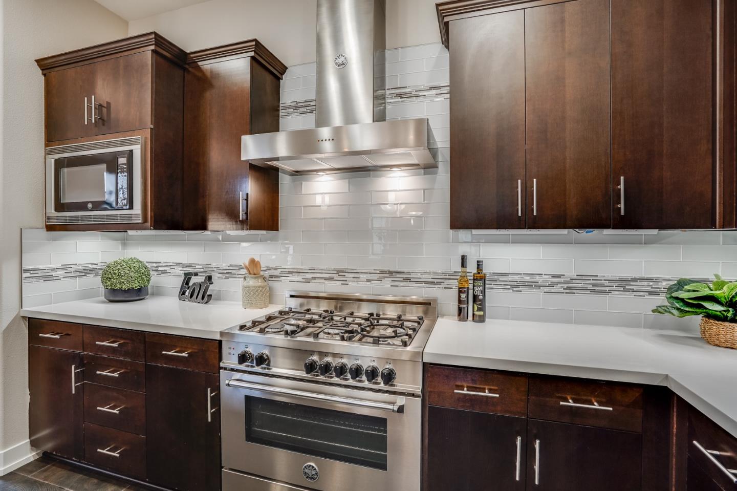 465 Landeros Drive San Mateo, CA 94403 - Photo 8 of 36 a kitchen with stainless steel appliances wooden cabinets and a stove top oven