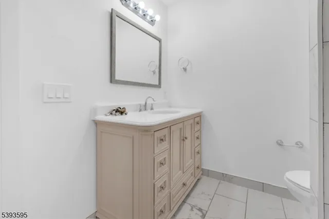 a bathroom with a sink a toilet and mirror