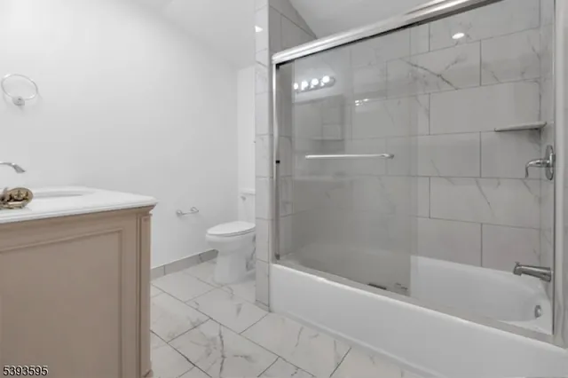 a bath room with a toilet sink and a bath tub