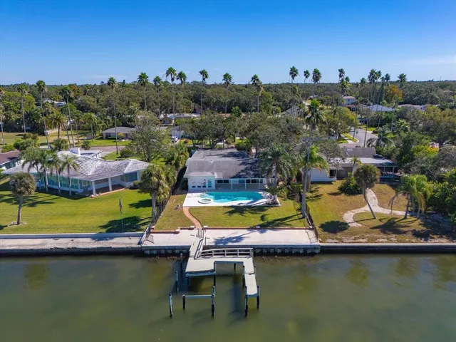 an aerial view of residential houses with outdoor space and swimming pool