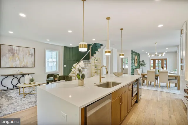 a view of a kitchen with kitchen island stainless steel appliances and a center island