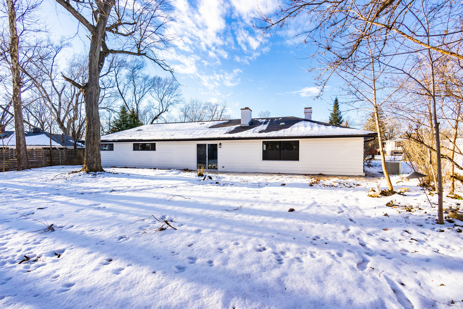 1913 Martingale Road Wheaton, IL 60187 - Photo 29 of 36 a view of a white house with a yard covered in snow