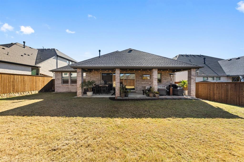 1340 Cartona Road Fate, TX 75087 - Photo 26 of 32 a front view of a house with garden