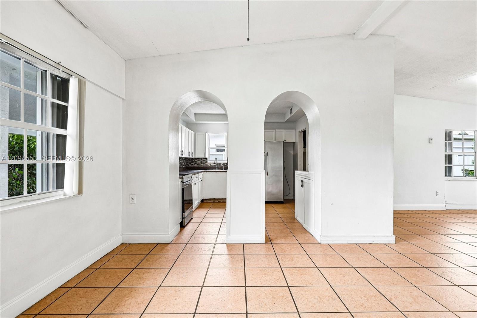 571 Northeast 172nd Street North Miami Beach, FL 33162 - Photo 12 of 33 Arched openings into the kitchen