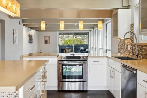 a kitchen with a refrigerator and a stove