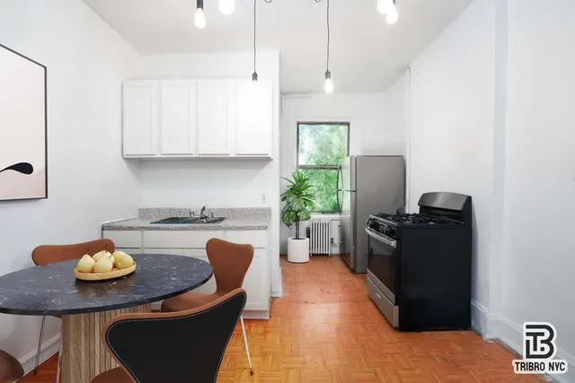 a kitchen with a table and chairs in it