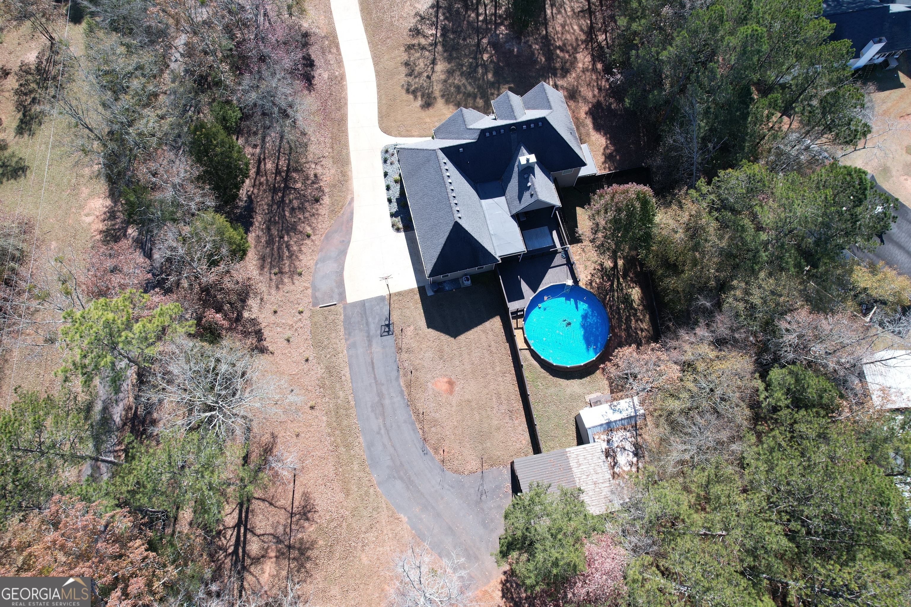 430 Bethany Road Covington, GA 30016 - Photo 4 of 39 an aerial view of a backyard with chairs and fire pit