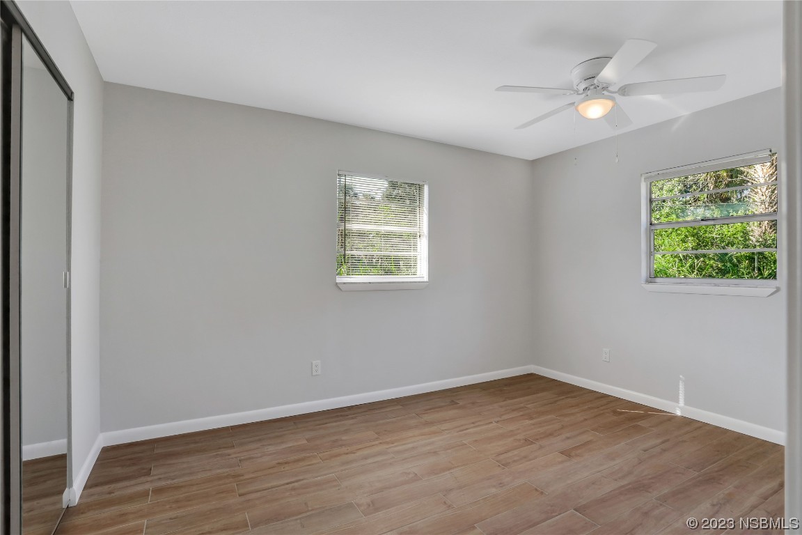 436 Palmetto Street Edgewater, FL 32132 - Photo 15 of 36 an empty room with wooden floor and windows