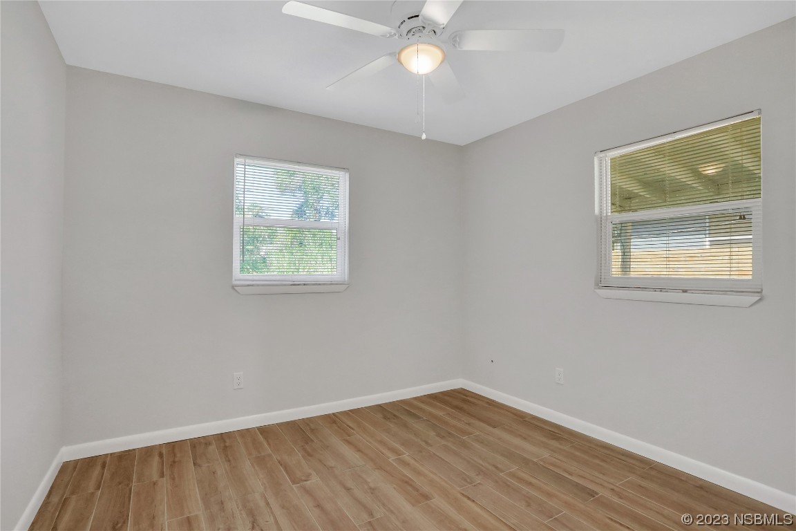 436 Palmetto Street Edgewater, FL 32132 - Photo 17 of 36 a view of an empty room with wooden floor and a window