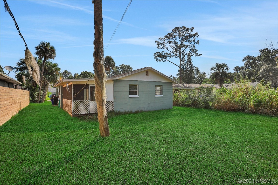 436 Palmetto Street Edgewater, FL 32132 - Photo 26 of 36 a front view of a house with garden