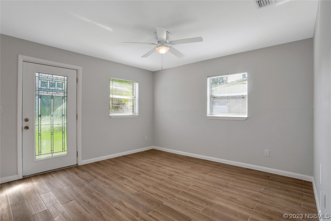 436 Palmetto Street Edgewater, FL 32132 - Photo 3 of 36 a view of an empty room with wooden floor and a window
