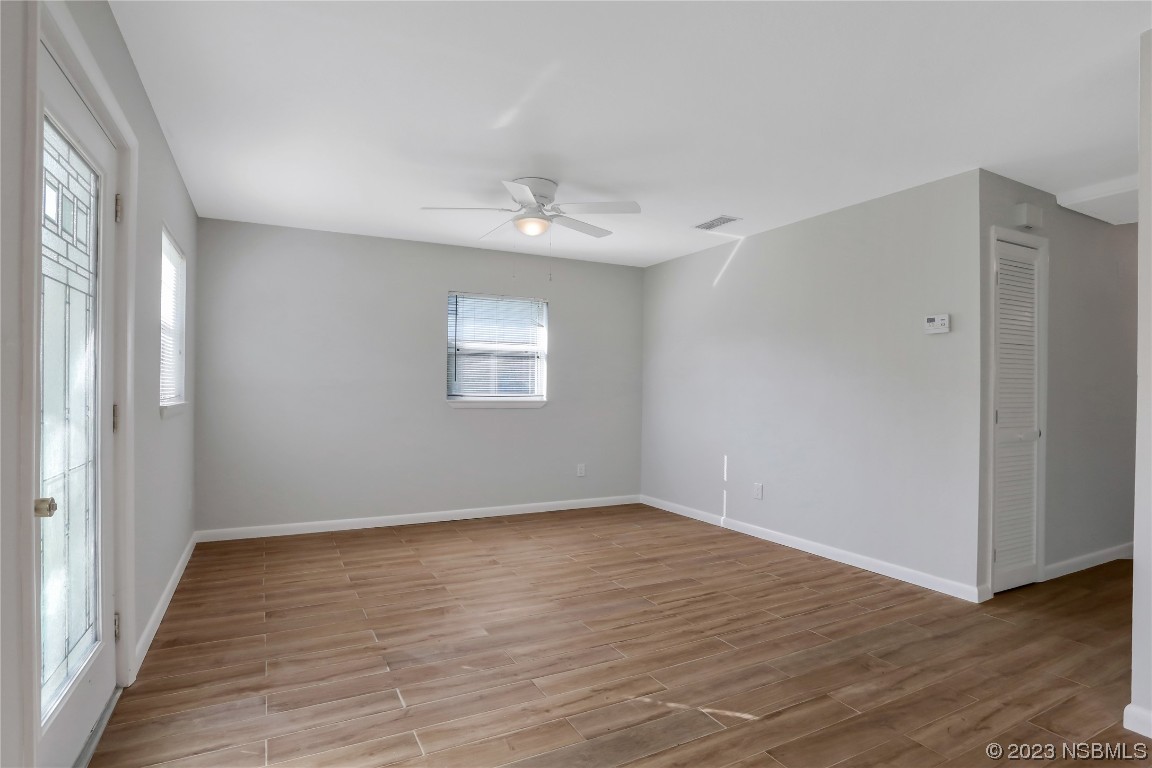 436 Palmetto Street Edgewater, FL 32132 - Photo 5 of 36 a view of an empty room with wooden floor and a window