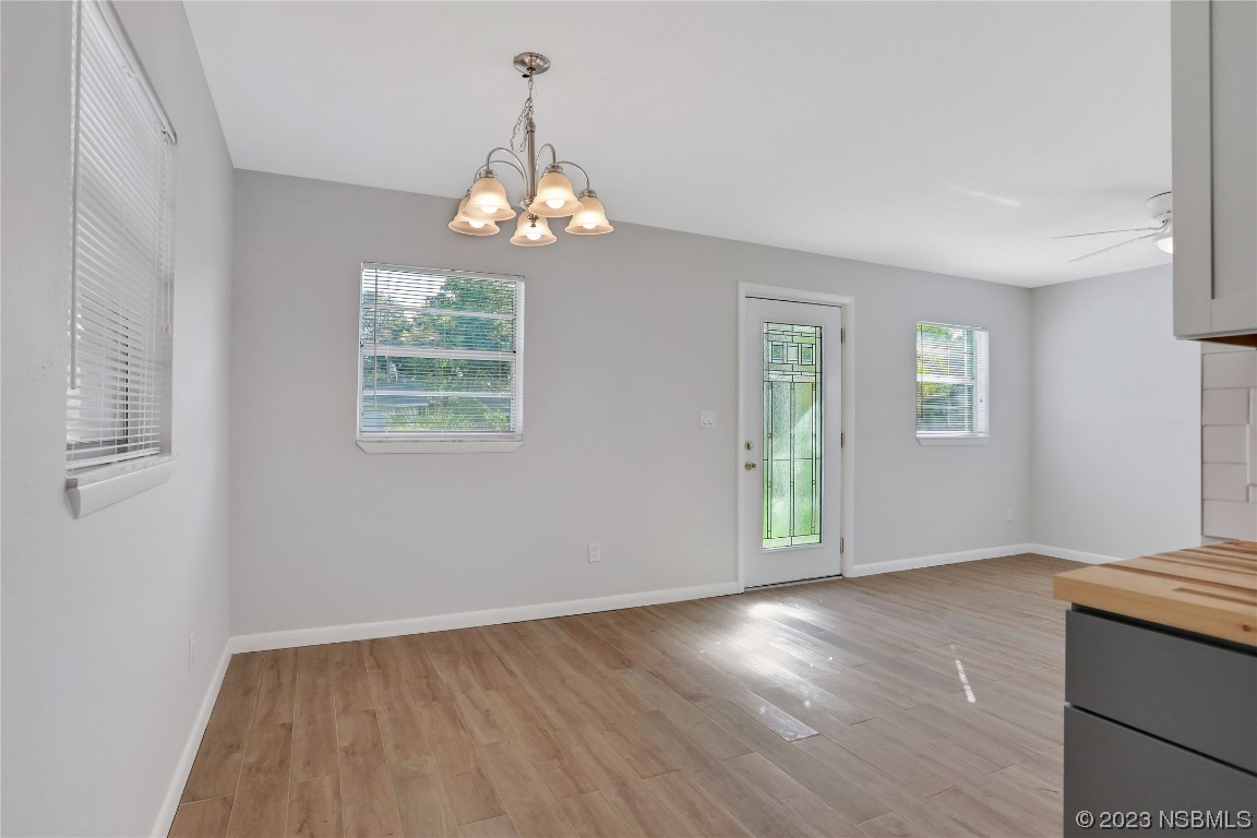436 Palmetto Street Edgewater, FL 32132 - Photo 7 of 36 wooden floor in an empty room with a window