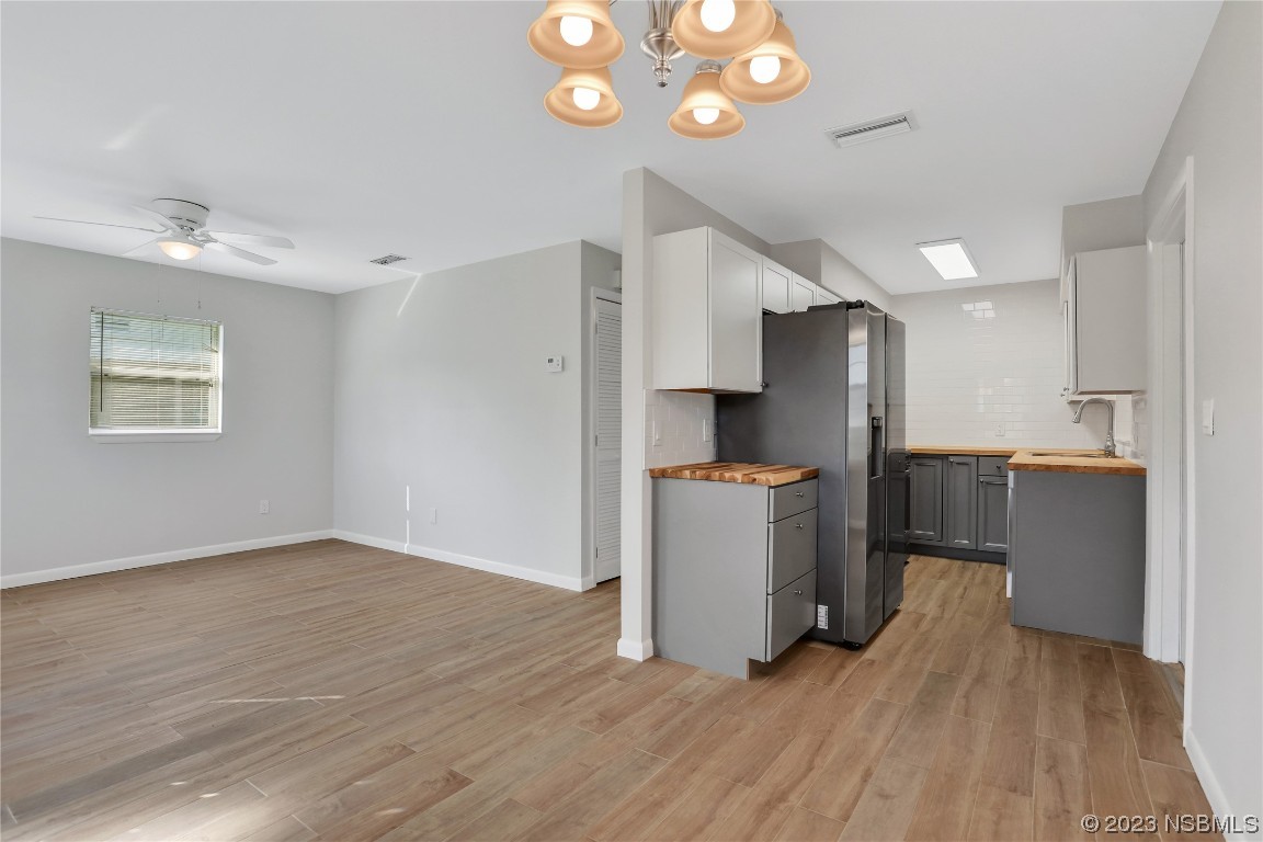 436 Palmetto Street Edgewater, FL 32132 - Photo 8 of 36 a kitchen with stainless steel appliances a refrigerator and a wooden floor