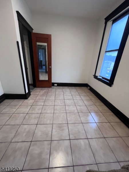 154 Spring Street Orange, NJ 07050 - Photo 5 of 8 a view of a livingroom with a washer and dryer
