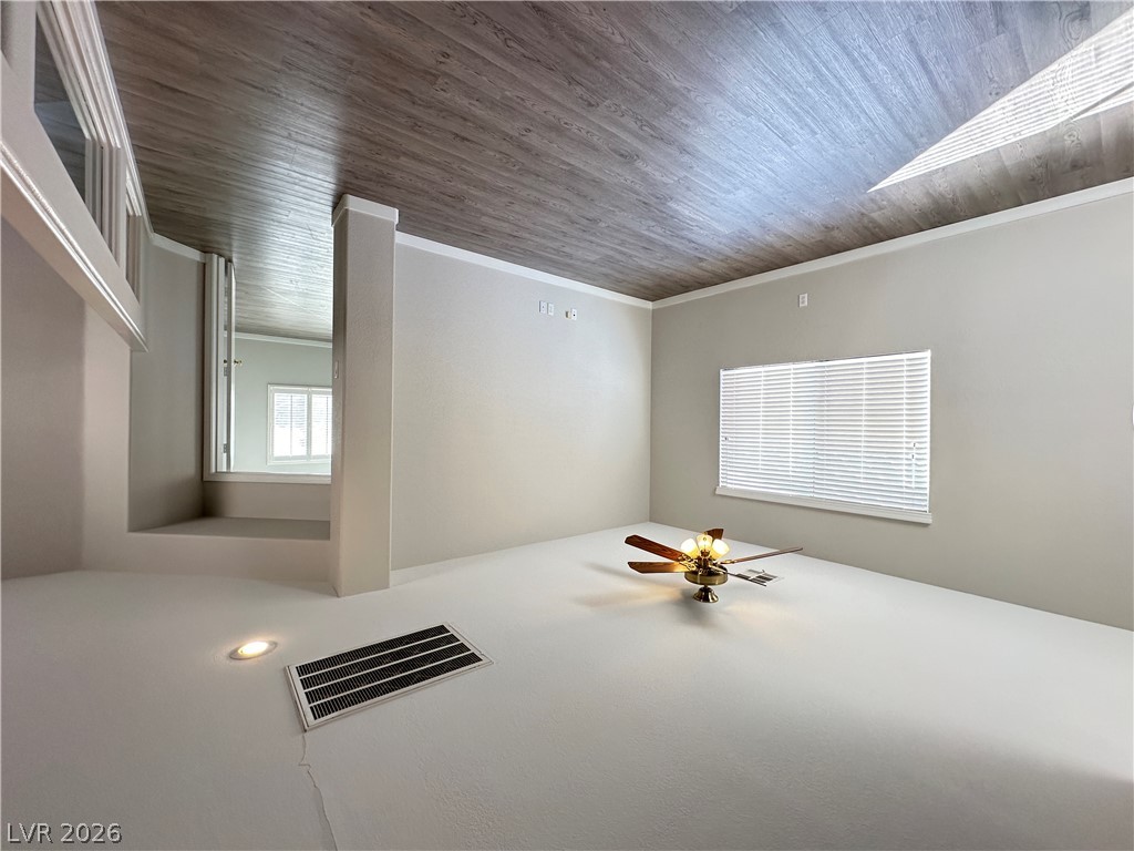 10191 Splendor Ridge Avenue Las Vegas, NV 89135 - Photo 24 of 31 A versatile open space with wood plank ceilings and recessed lighting, ready for your personalized touch.