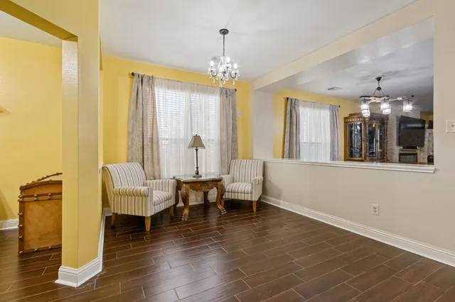 a living room with couches and chandelier