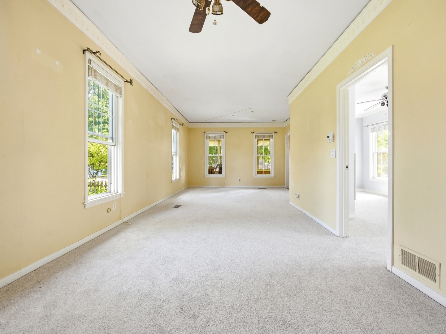 570 Addison Street Elgin, IL 60120 - Photo 7 of 17 a view of an empty room with chandelier fan and window