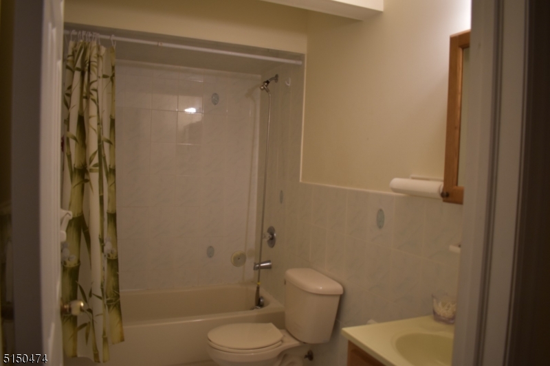 14 Hunter Street, Unit 1 Newark, NJ 07114 - Photo 2 of 9 a bathroom with a shower a toilet and a sink