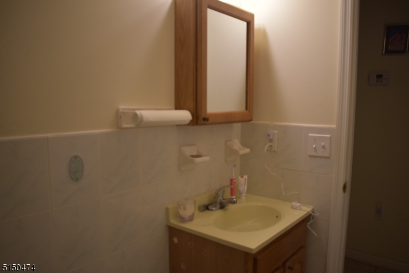 14 Hunter Street, Unit 1 Newark, NJ 07114 - Photo 3 of 9 a bathroom with a sink and a mirror