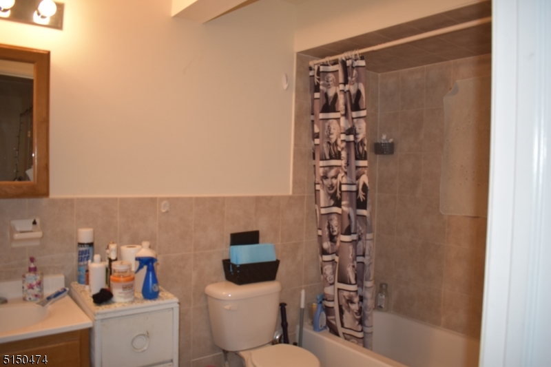 14 Hunter Street, Unit 1 Newark, NJ 07114 - Photo 4 of 9 a bathroom with a shower a toilet and sink