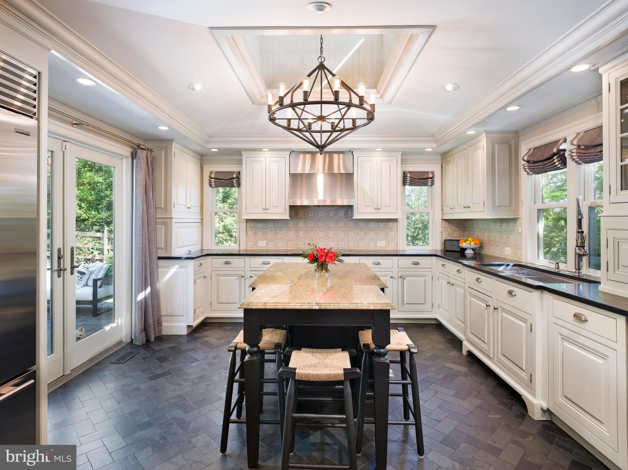 813 Hunt Road Newtown Square, PA 19073 - Photo 13 of 49 a kitchen with a table chairs sink and cabinets