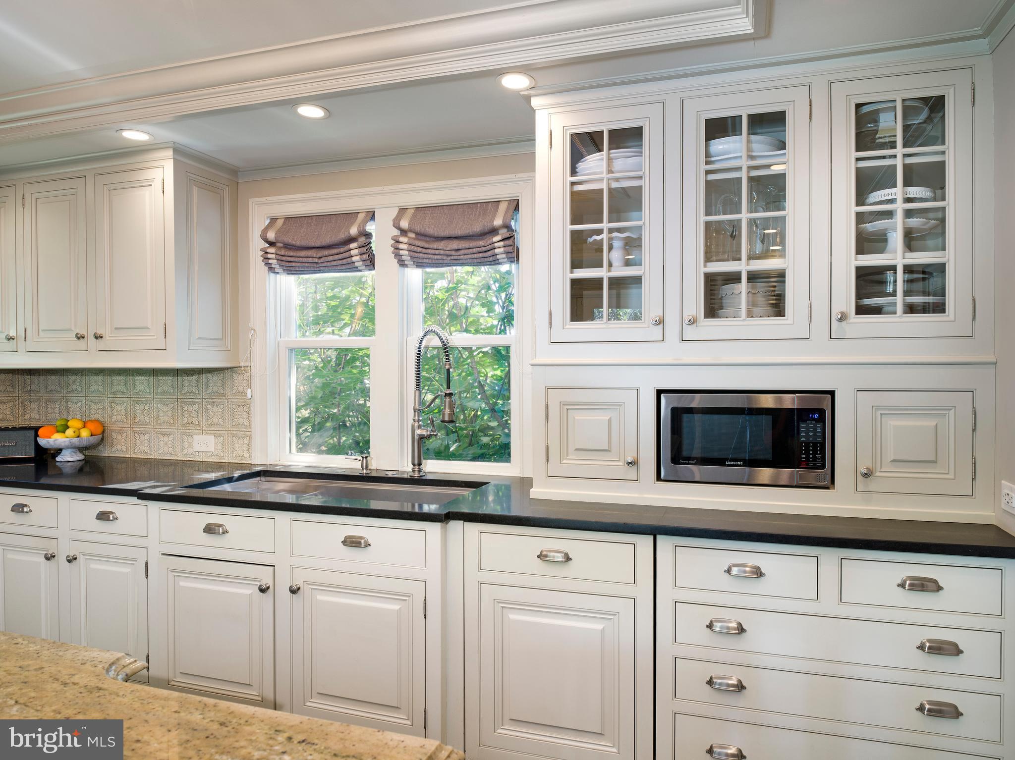 813 Hunt Road Newtown Square, PA 19073 - Photo 14 of 49 a kitchen with granite countertop white cabinets stainless steel appliances and a window