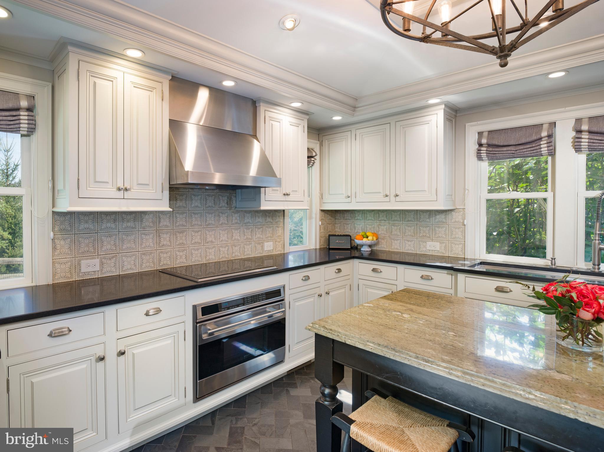 813 Hunt Road Newtown Square, PA 19073 - Photo 16 of 49 a kitchen with granite countertop a stove a sink and white cabinets