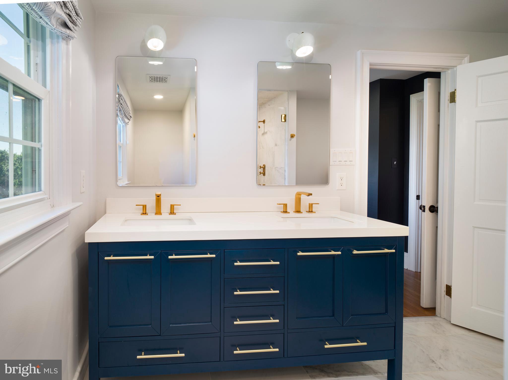 813 Hunt Road Newtown Square, PA 19073 - Photo 32 of 49 a bathroom with a sink double vanity and a mirror