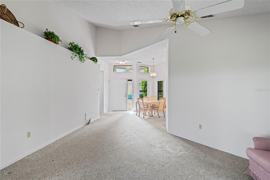 9108 Bassett Lane, Unit B New Port Richey, FL 34655 - Photo 17 of 66 a view of a bedroom with a bed and a chandelier
