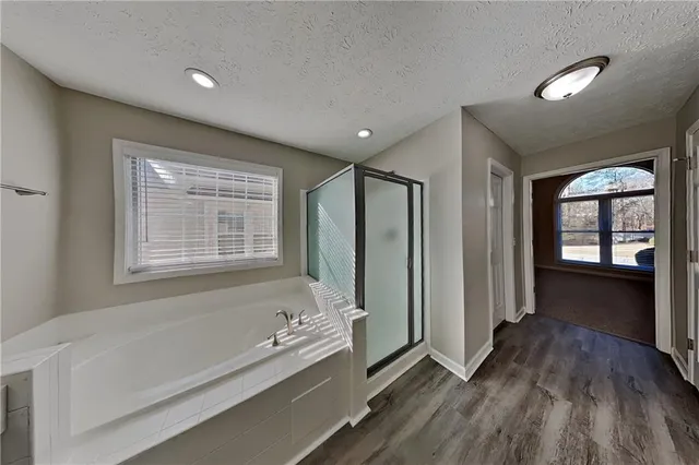 a spacious bathroom with a bathtub and a shower