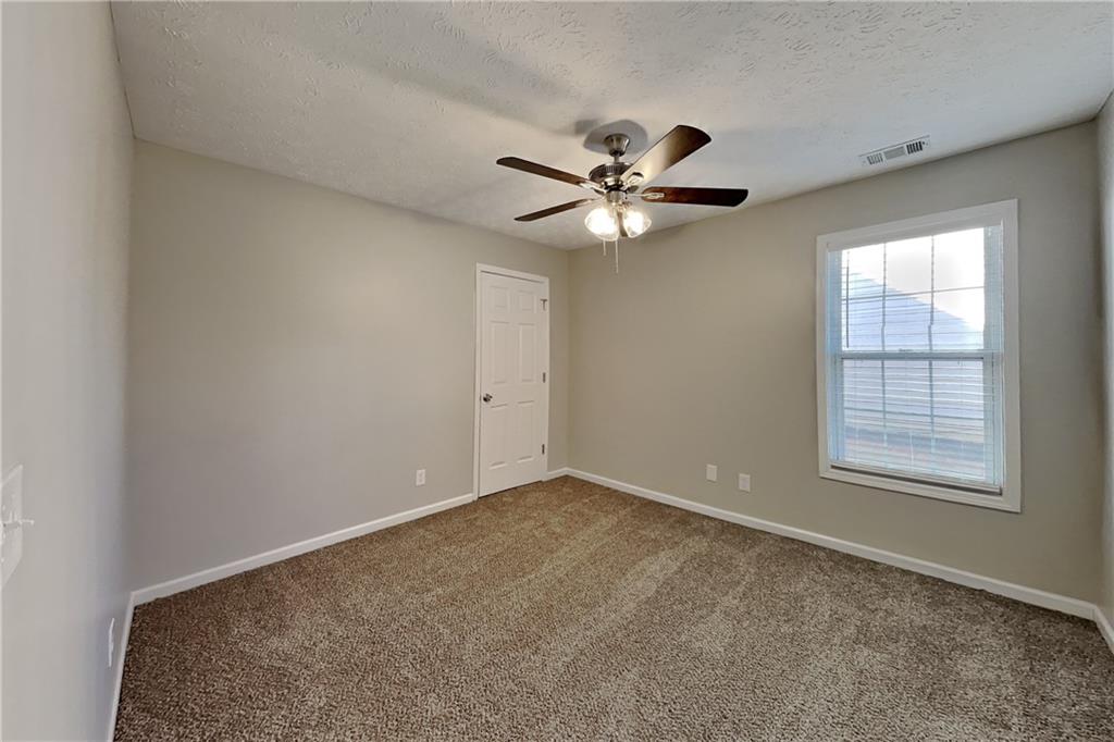 2097 Corsica Way Southwest Marietta, GA 30008 - Photo 13 of 25 an empty room with windows and fan