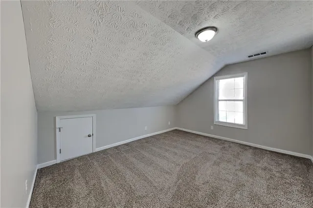 an empty room with a empty space and windows