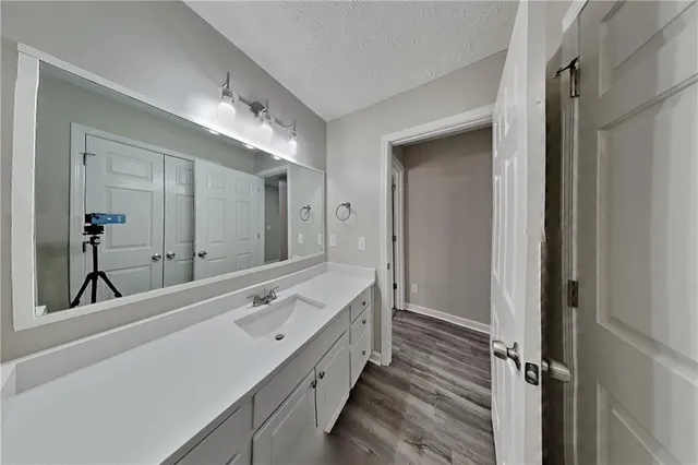 a spacious bathroom with a double vanity sink and mirror