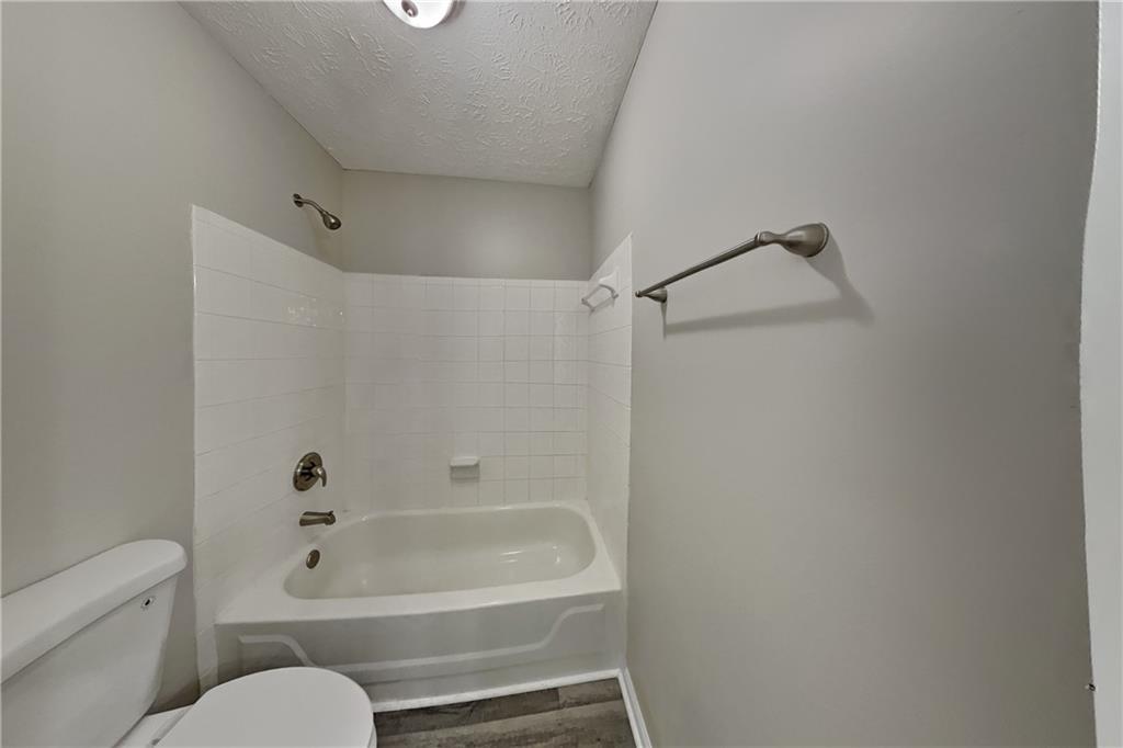 2097 Corsica Way Southwest Marietta, GA 30008 - Photo 18 of 25 a bathroom with a toilet and a bathtub
