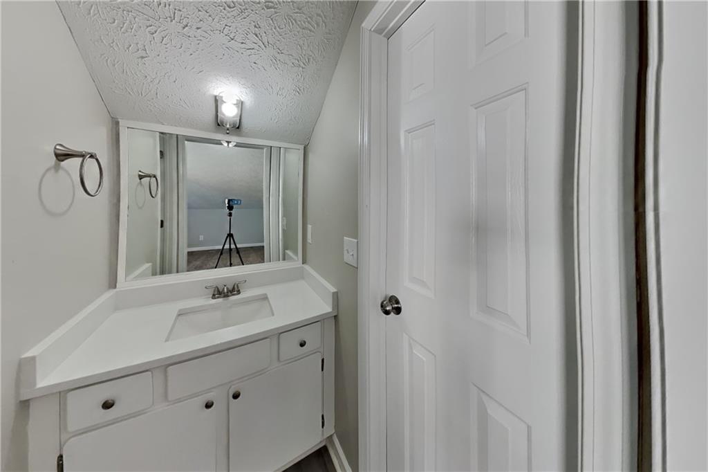 2097 Corsica Way Southwest Marietta, GA 30008 - Photo 20 of 25 a bathroom with a sink and a mirror