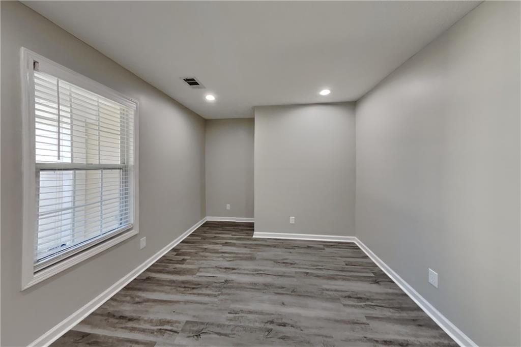 2097 Corsica Way Southwest Marietta, GA 30008 - Photo 21 of 25 a view of an empty room with wooden floor and a window