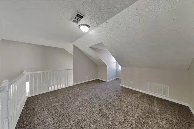 a view of an empty room with stairs