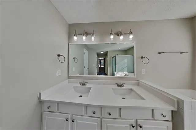 a bathroom with a sink vanity and mirror