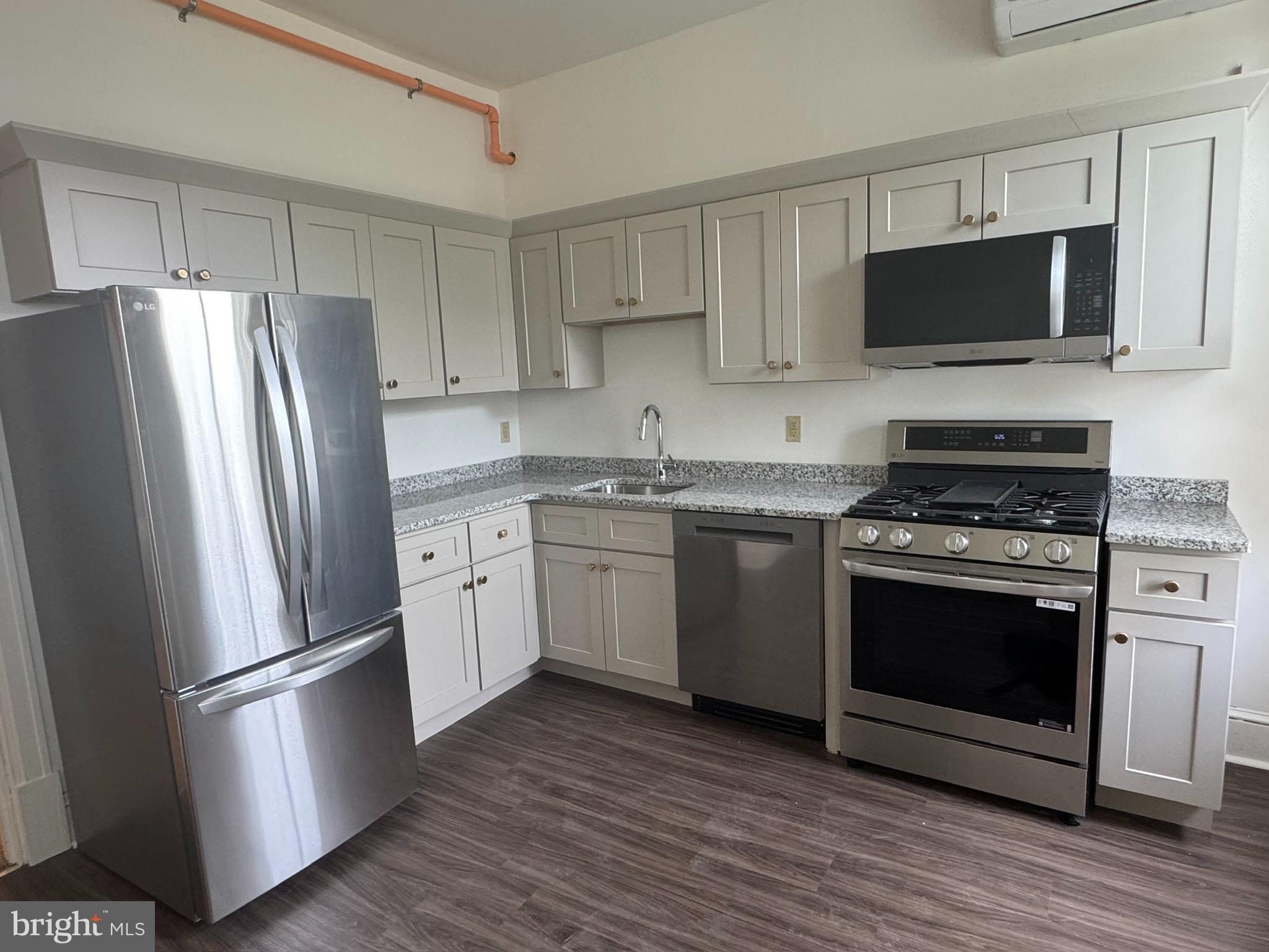 105 Ardmore Avenue Ardmore, PA 19003 - Photo 2 of 6 a kitchen with stainless steel appliances a refrigerator stove and microwave