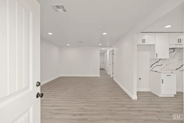 a view of a hallway with wooden floor