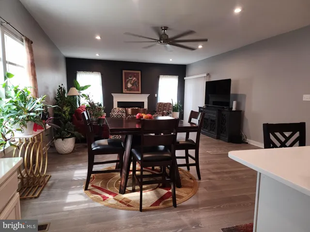 a living room with furniture fireplace and a large window