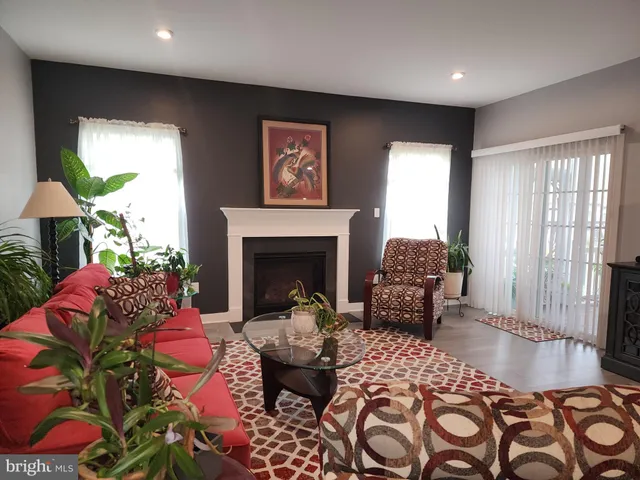 a living room with lots of furniture and a large window