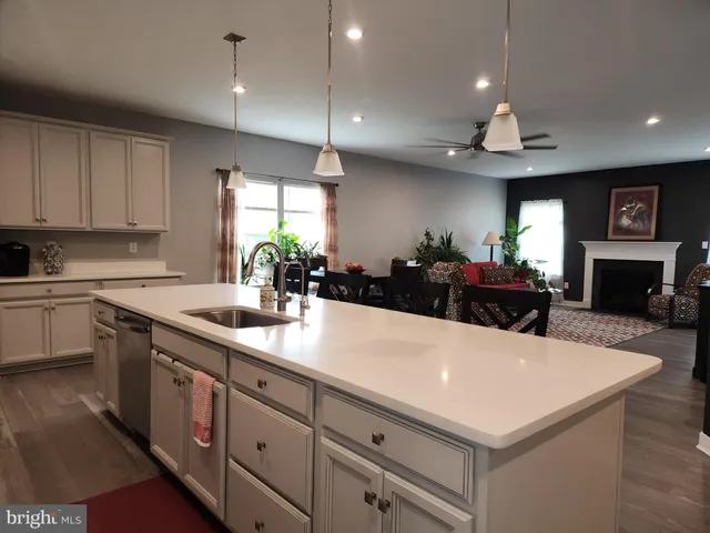 a large kitchen with kitchen island a sink stainless steel appliances and a counter top