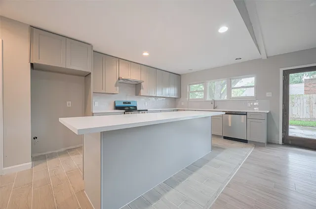 a kitchen with a white cabinets counter space a sink and appliances